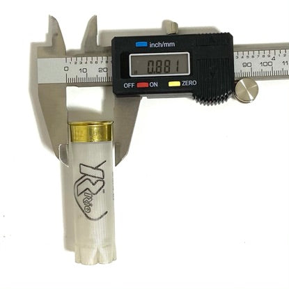 A clear translucent 12 gauge empty shotshell casing base being measured across its diameter with a digital caliper showing 0.881 inches, on a white background.
