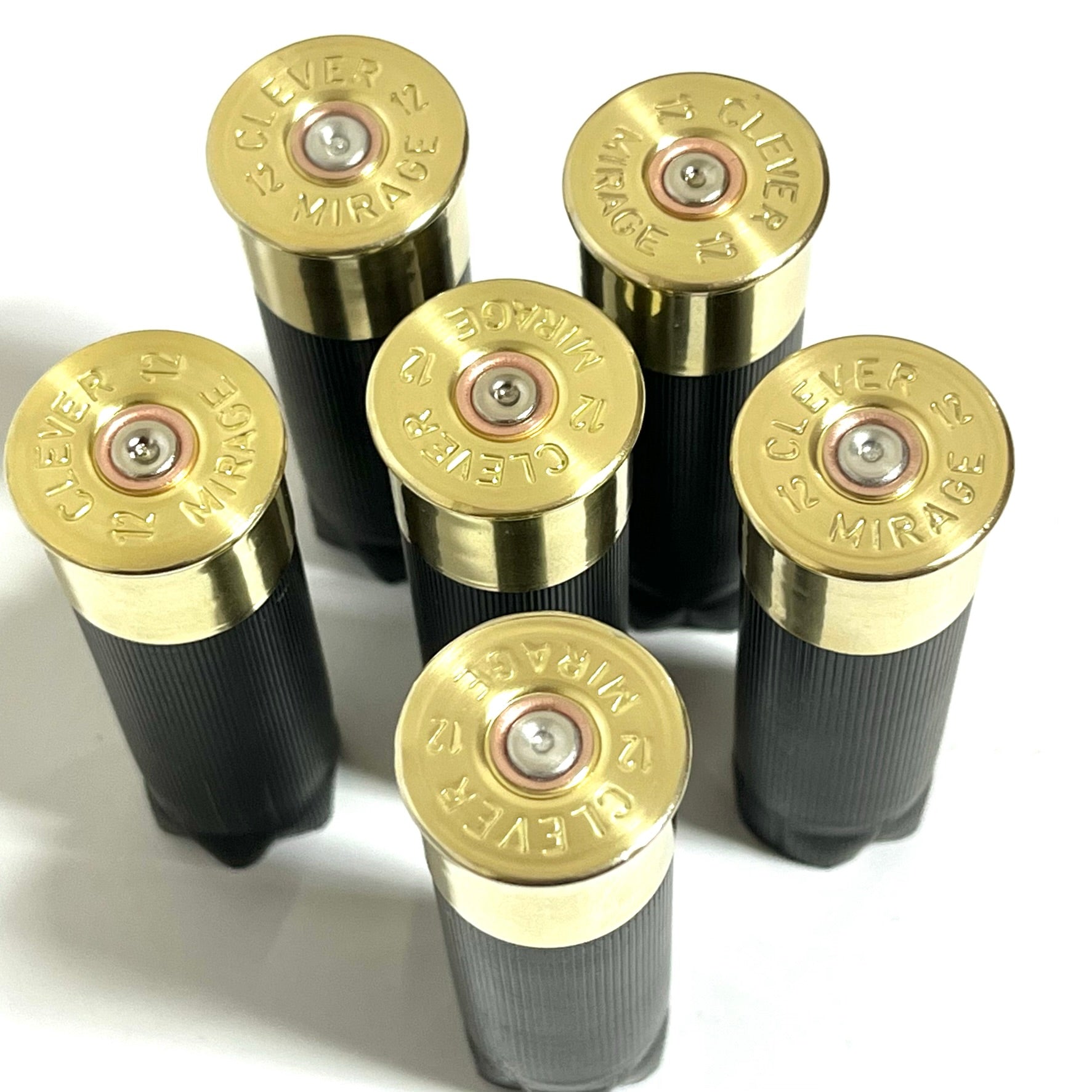 Six black 12-gauge unmarked cartridges with polished brass Clever Mirage headstamps, standing upright