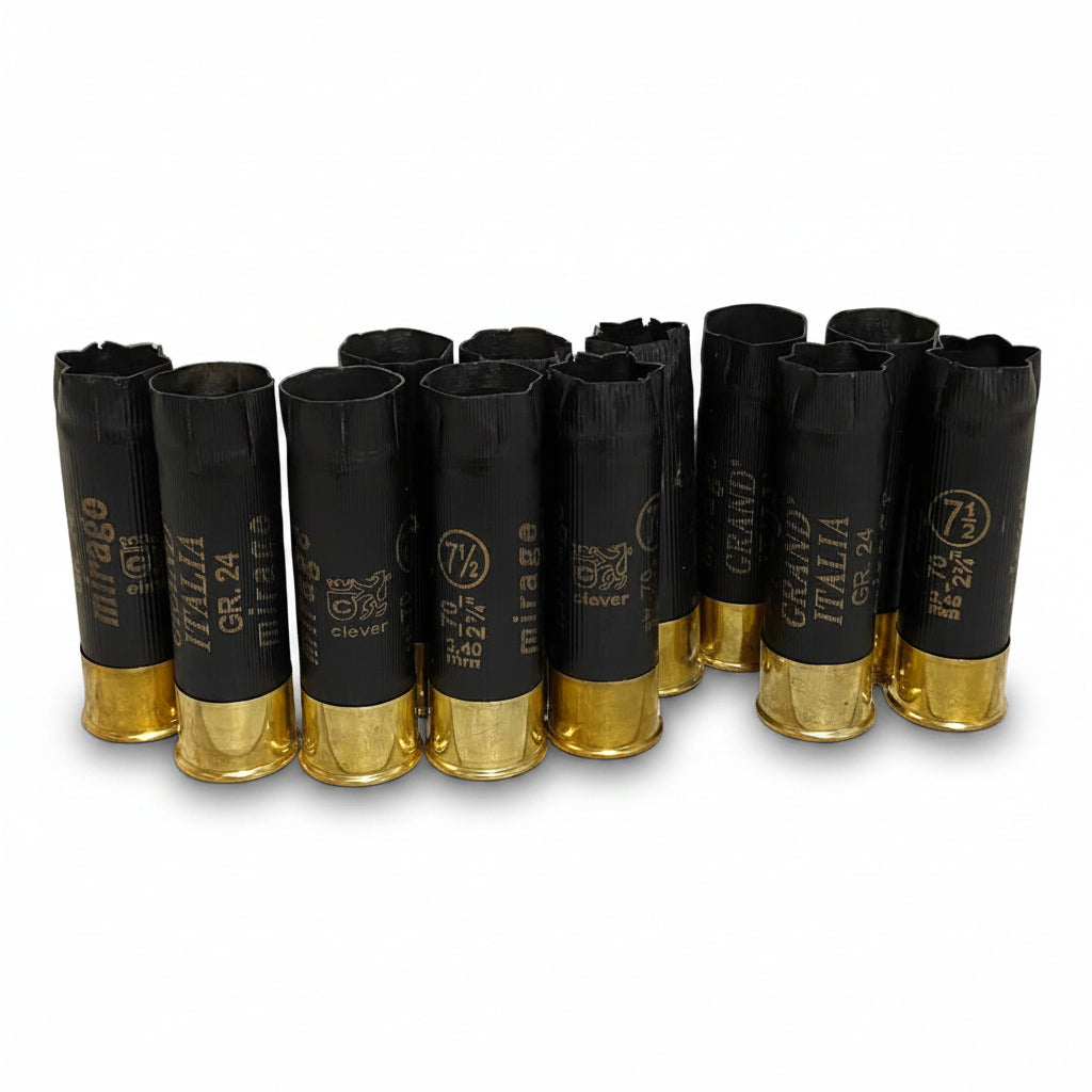 Black Clever Mirage Italia 12 gauge shotgun hulls standing in a row with brass bases, showing mixed headstamps.