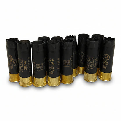 Black Clever Mirage Italia 12 gauge shotgun hulls standing in a row with brass bases, showing mixed headstamps.
