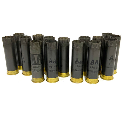 Fifteen dark gray Winchester AA hulls standing upright on their brass bases in three rows on a white background for crafting projects.