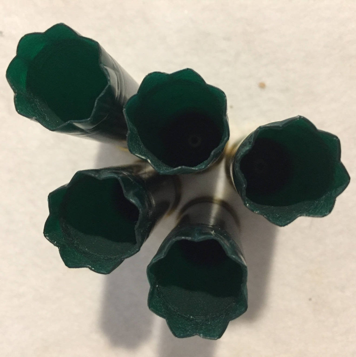Top View Of Five Dark Green Shotgun Hull Mouths