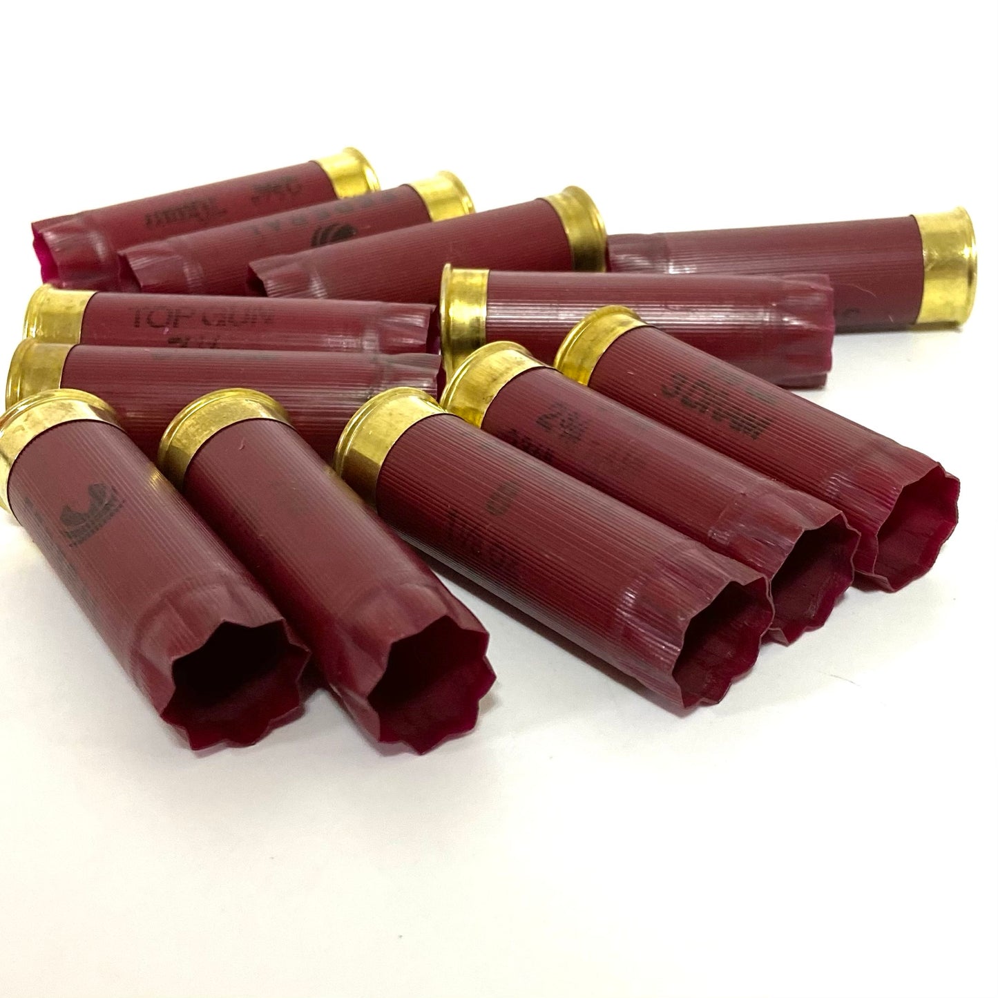 A cluster of dark red empty shotgun hulls perfectly suited for DIY ammo crafts.
