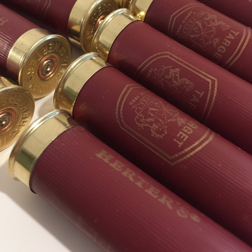 Dark Red Herter's Used 12GA Cartridges In A Diagonal Row