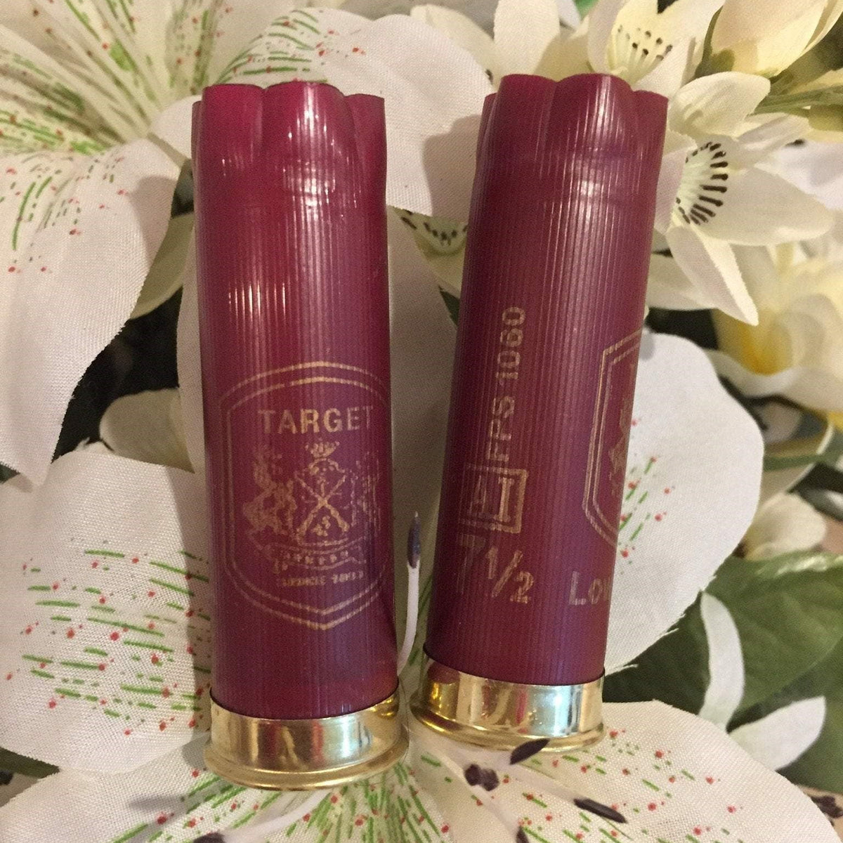 Two Dark Red Herter's Hulls Styled With Artificial Flowers