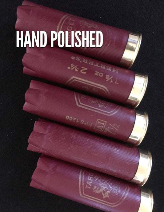 Five burgundy Herter’s Target 12 gauge shotgun shells stacked in a row on a black background, with ‘HAND POLISHED’ text overlay and printed ‘1 1/8 oz 2 3/4in’ load markings