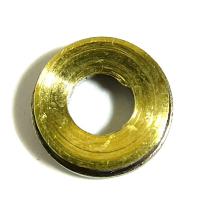 Macro view of the back side of a brass bullet slice on white, showing the hollow inner ring and open center hole.