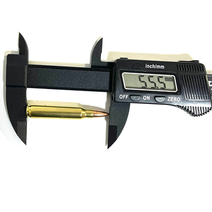 A black digital caliper measuring the overall length of a single brass dummy cartridge, showing a reading of 55.5 mm.