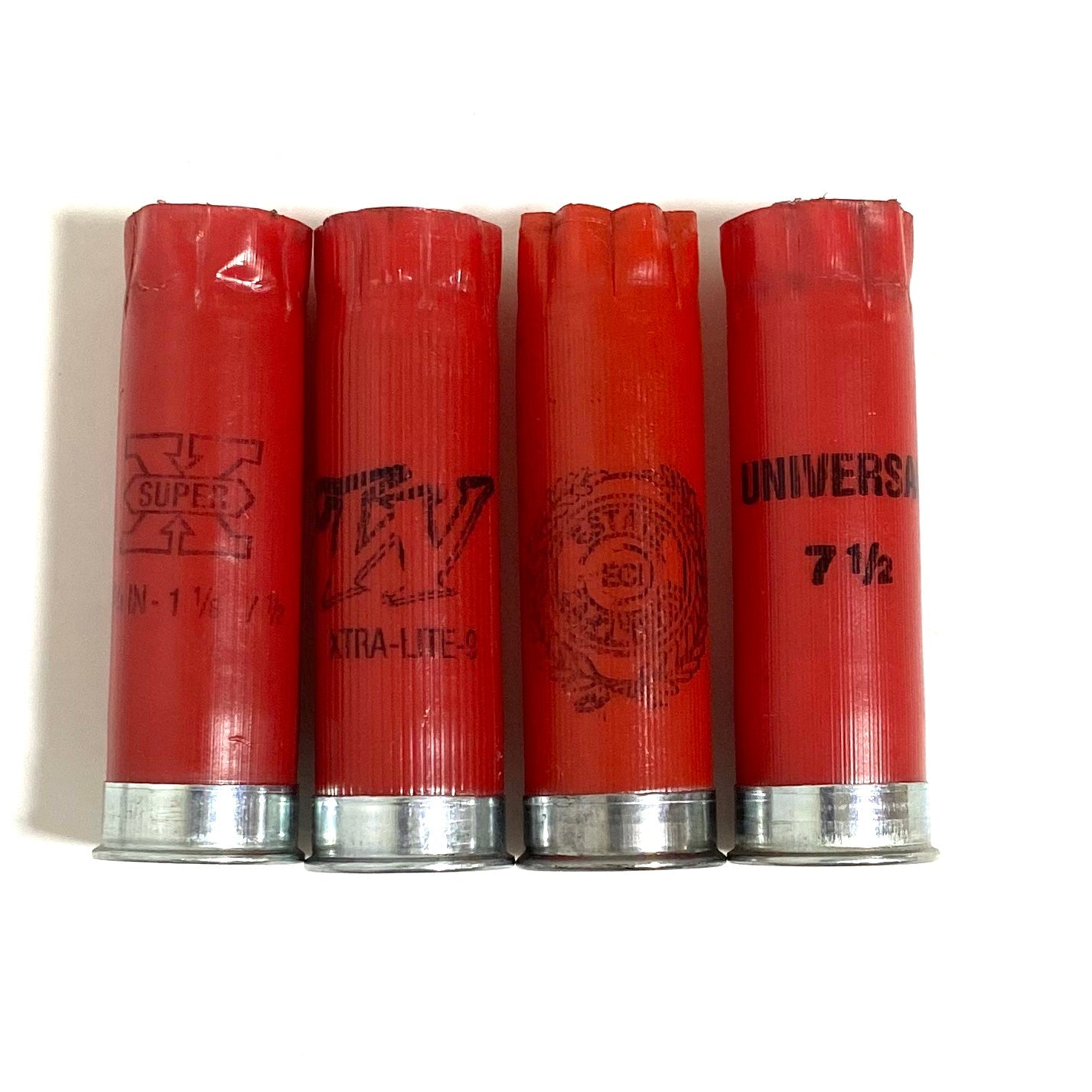 Four red 12 gauge empty shells with silver bases standing side by side in a straight row on a white background.