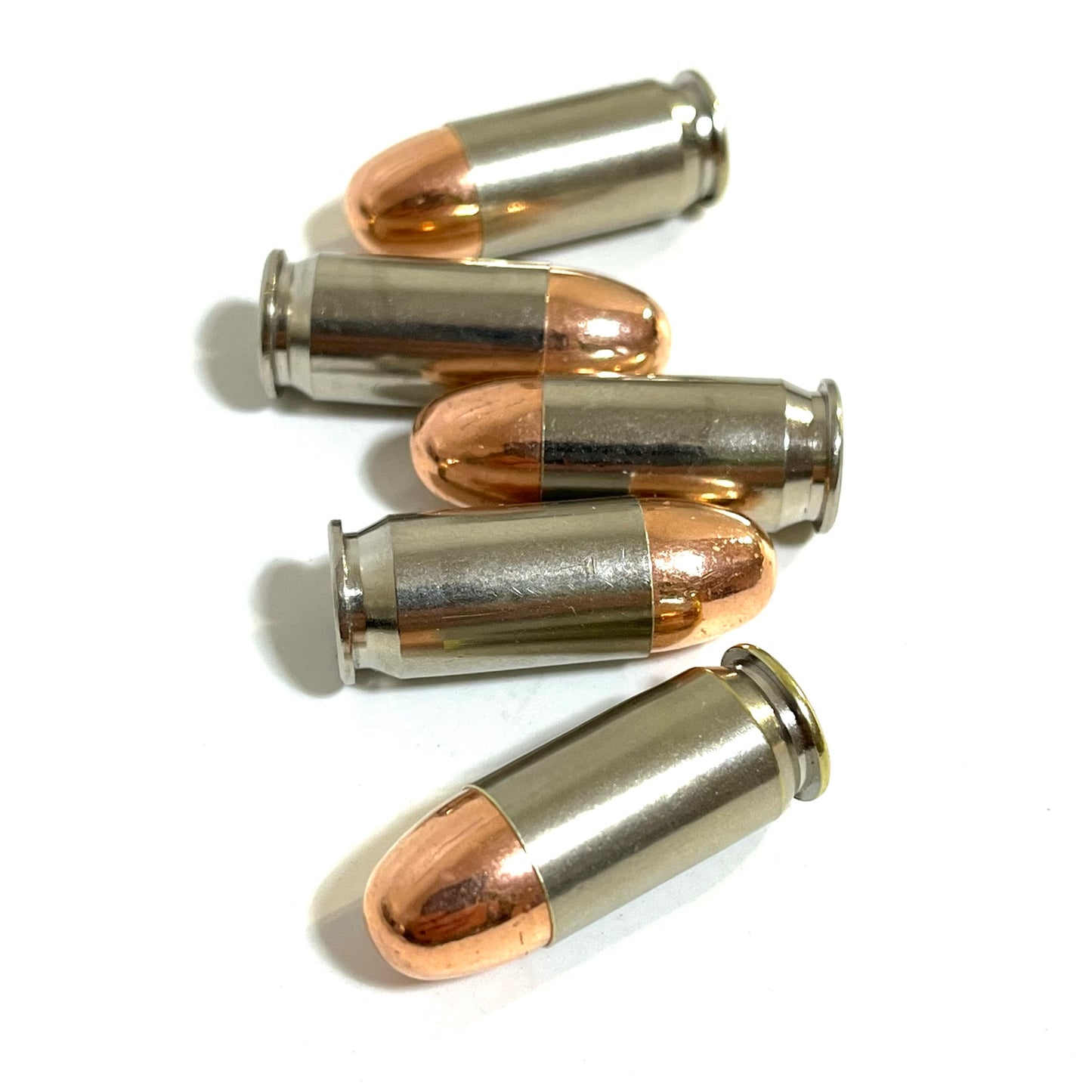 Five fake 45 caliber bullets with nickel casings and copper tips stacked horizontally on a white background.