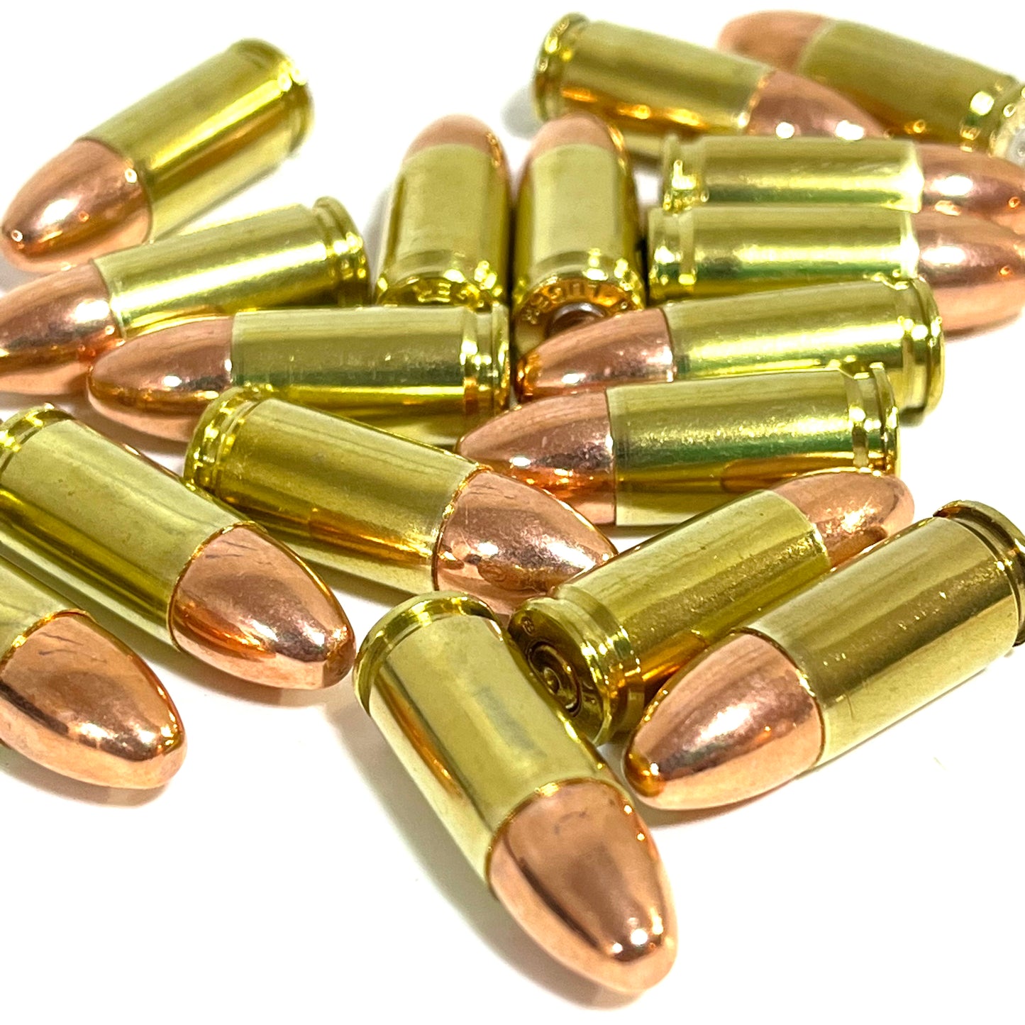 Pile of 9mm dummy rounds with polished brass casings and round-nose bullets by Empty Shotgun Shells.

