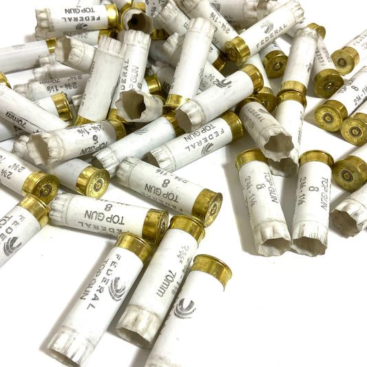 Large pile of empty white Federal Top Gun 12ga hulls with gold brass heads, marked 2 3/4-1 1/8-8