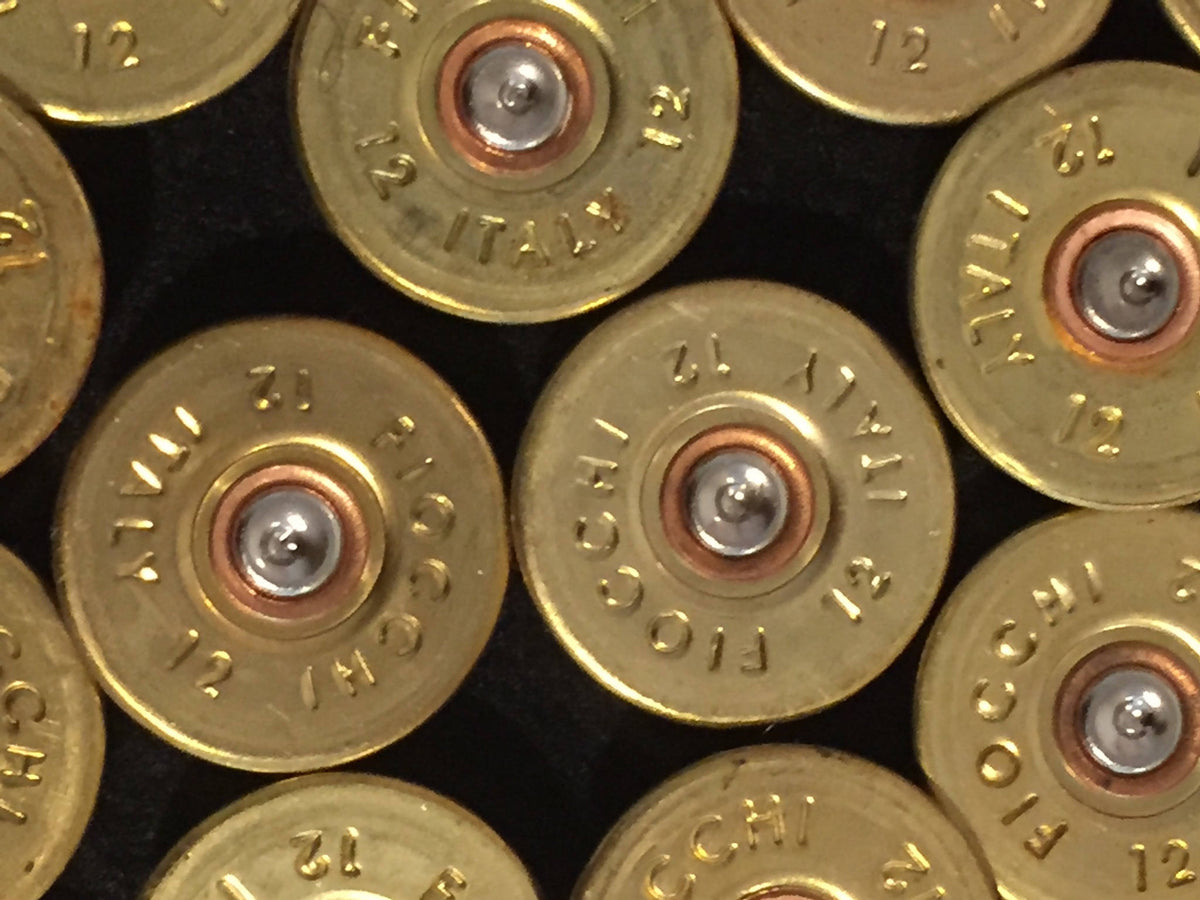Close-up of gold brass Fiocchi 12 gauge headstamps showing engraved Fiocchi Italy 12 text