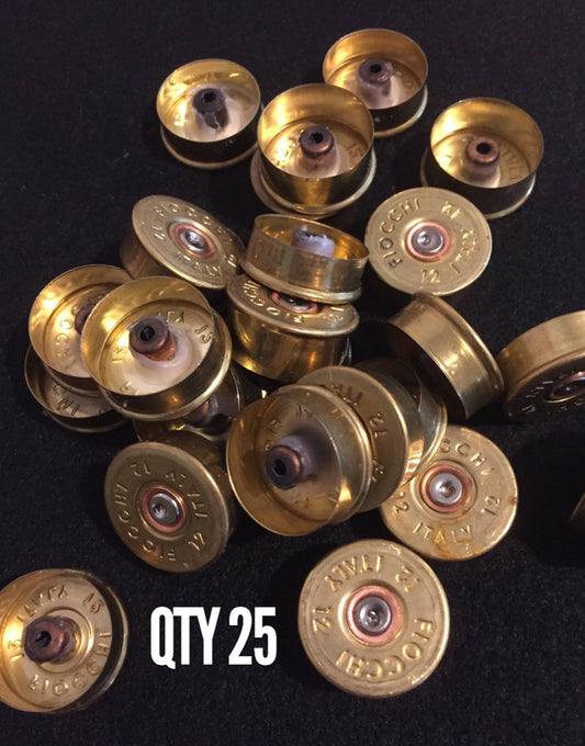 Pile of gold brass Fiocchi 12 gauge shotgun shell headstamps on a black surface, text reading QTY 25