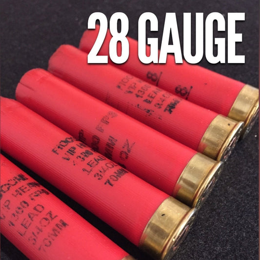 Five red Fiocchi 28 gauge shotgun shell hulls with a bold "28 GAUGE" text overlay