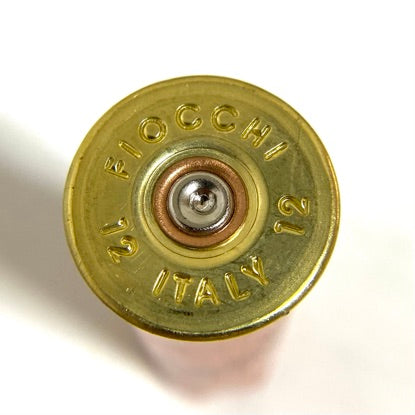 Close-up of a fired Fiocchi shell headstamp, stamped FIOCCHI ITALY 12 on a brass base.