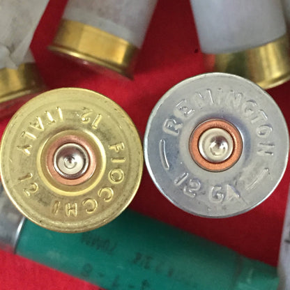 Second close-up of a brass Fiocchi and silver Remington 12 gauge shotgun shell headstamp pair