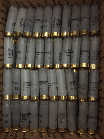 Rows of translucent Fiocchi 12 gauge shotgun shell hulls packed in a shipping box