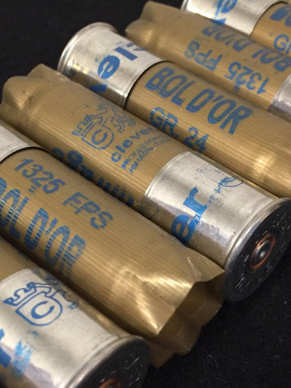 Gold shotgun shells with silver bases lying in rows printed "Bol D'Or", "GR.24", "1325 FPS", "clever"