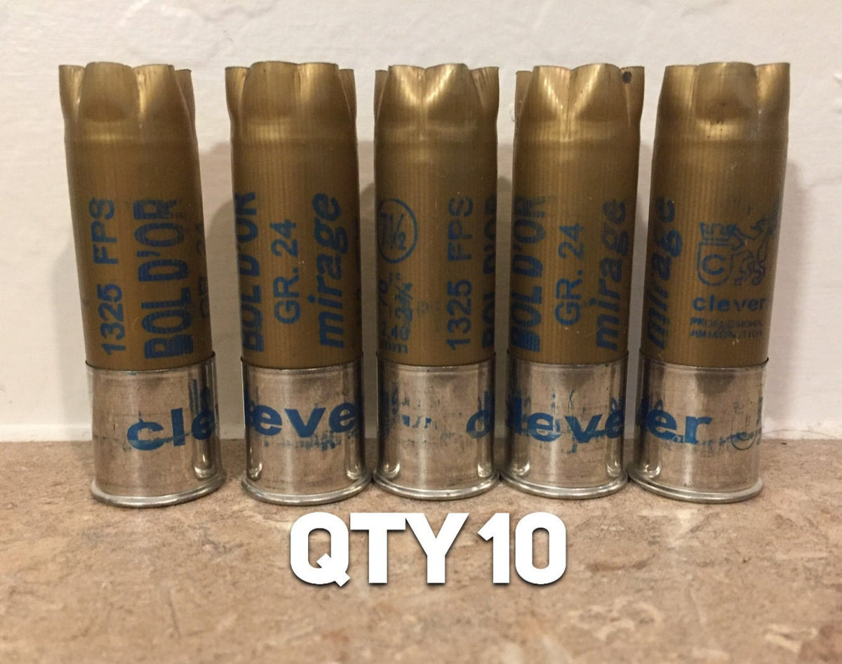 5 gold shotgun shells with silver bases standing upright printed "Bol D'Or", "1325 FPS", "GR.24", "mirage", "clever" text with "QTY 10" overlay