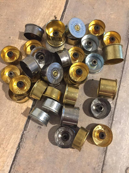 Multiple silver and gold 20 gauge headstamps spread flat.