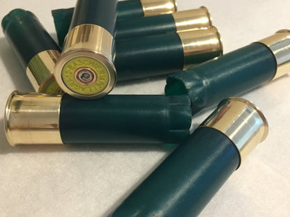 A pile of green shotgun shells, with one shell clearly showing the Baschieri & Pellagri headstamp.