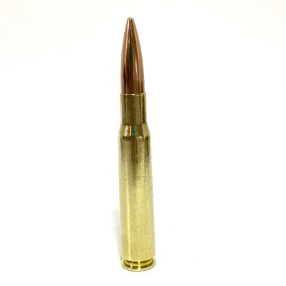 A single hand-polished BMG casing with an attached copper bullet standing upright on a clean white background.
