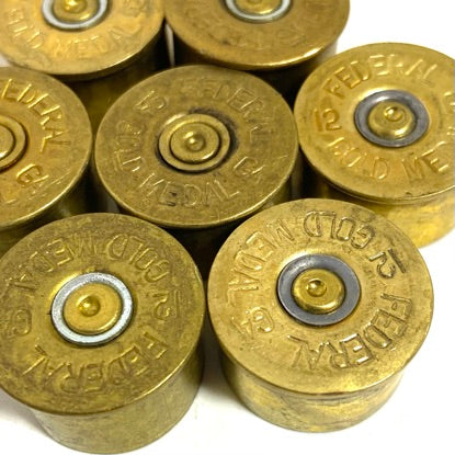 Used 12 gauge brass headstamps with mixed primer colors from firing