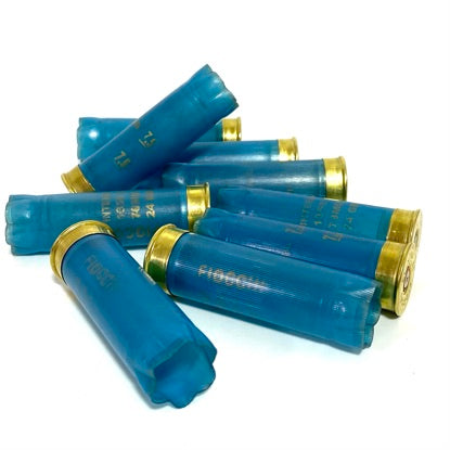Pile of light blue Fiocchi 12 gauge empty shotgun shells with gold bases on a white background