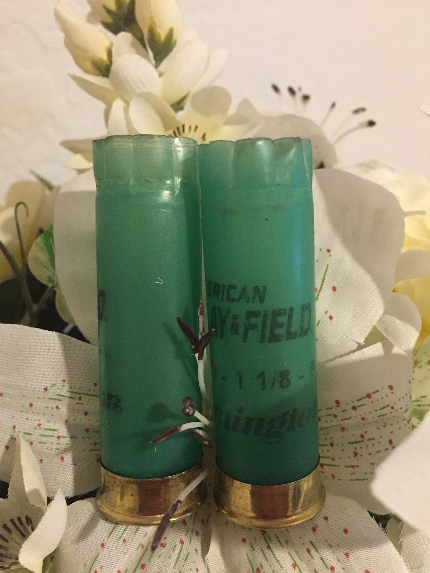 Two Light Green Remington Hulls Styled With Artificial Flowers