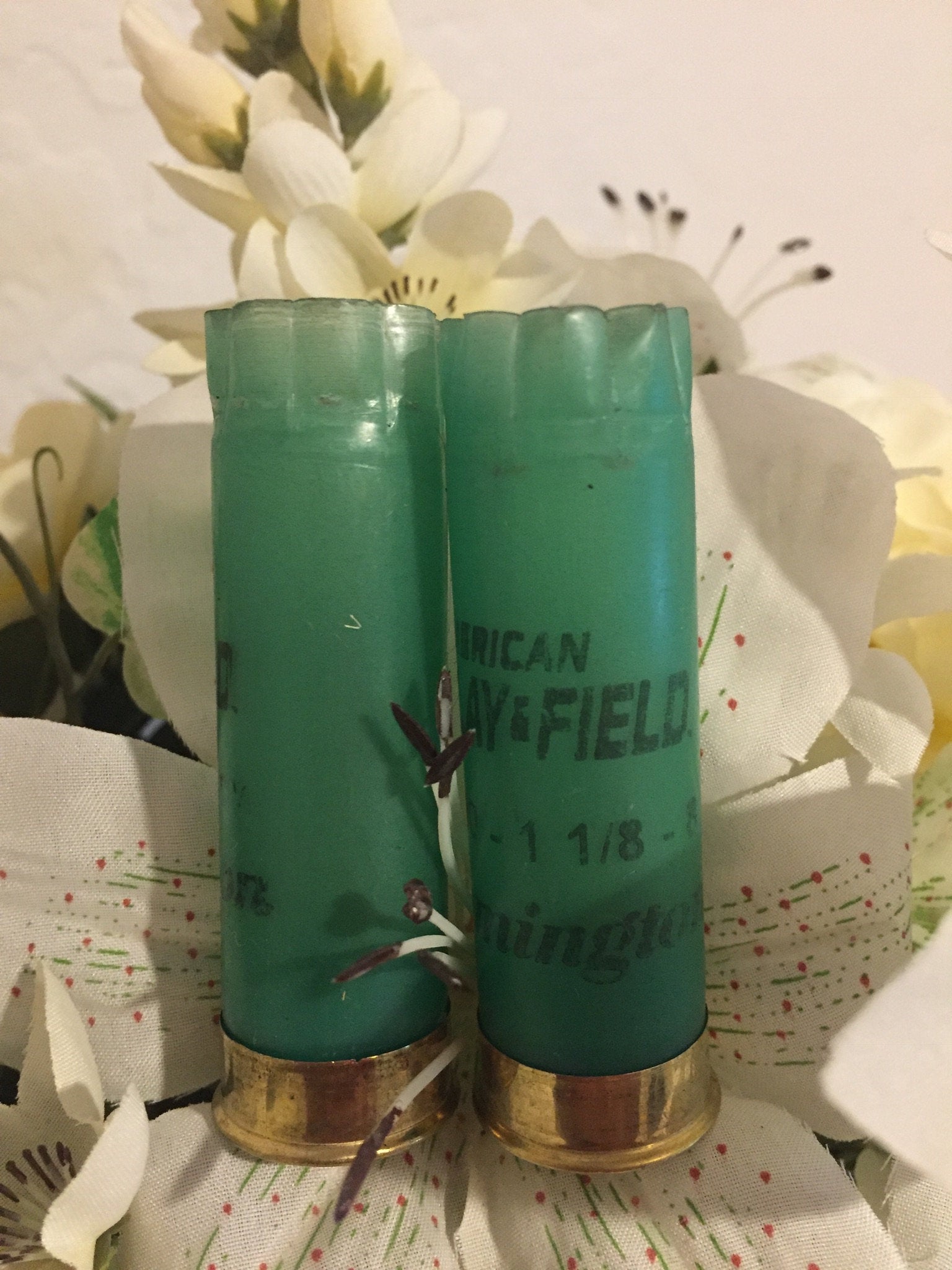 Two Light Green Remington Hulls Styled With Artificial Flowers