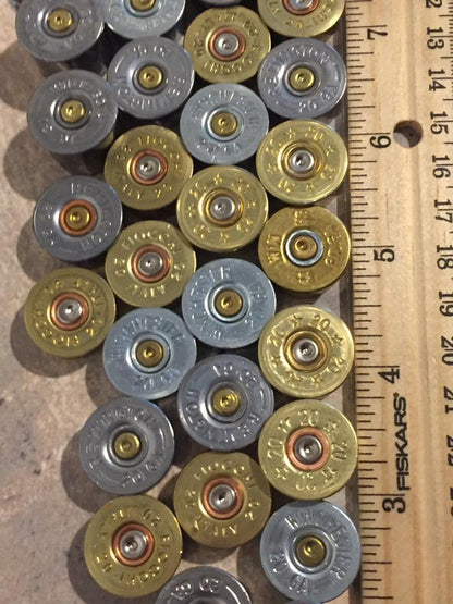 Assorted 20 gauge shotshell bases showing primer pockets.