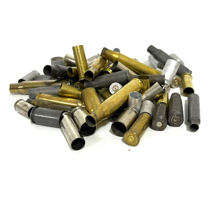 Bulk pile of mixed spent bullet casings in brass, nickel, and steel showing various metal finishes.