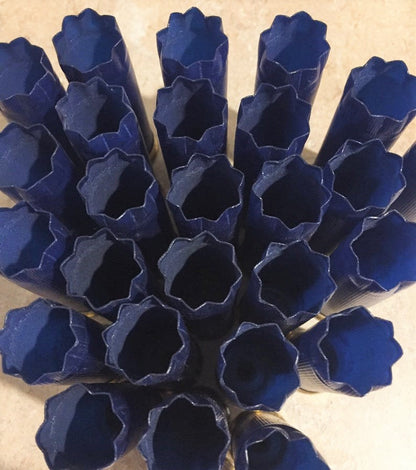 Navy blue shotgun shells with gold bottoms viewed from above showing open crimped tops