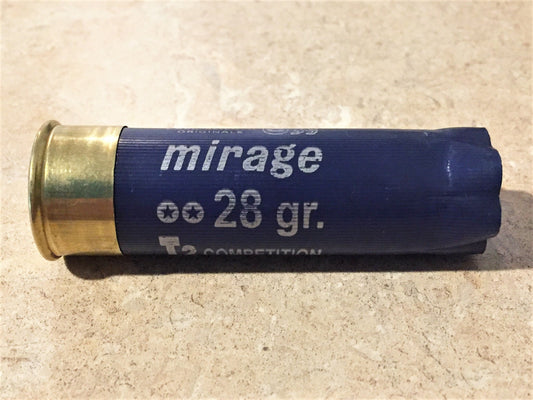 Single navy blue 12 gauge shotgun shell on its side on tile, gold brass base, mirage 28 gr T2 Competition text on hull