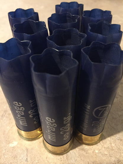 10 navy blue shotgun shells viewed from open crimped end, star-shaped crimp pattern visible on each hull