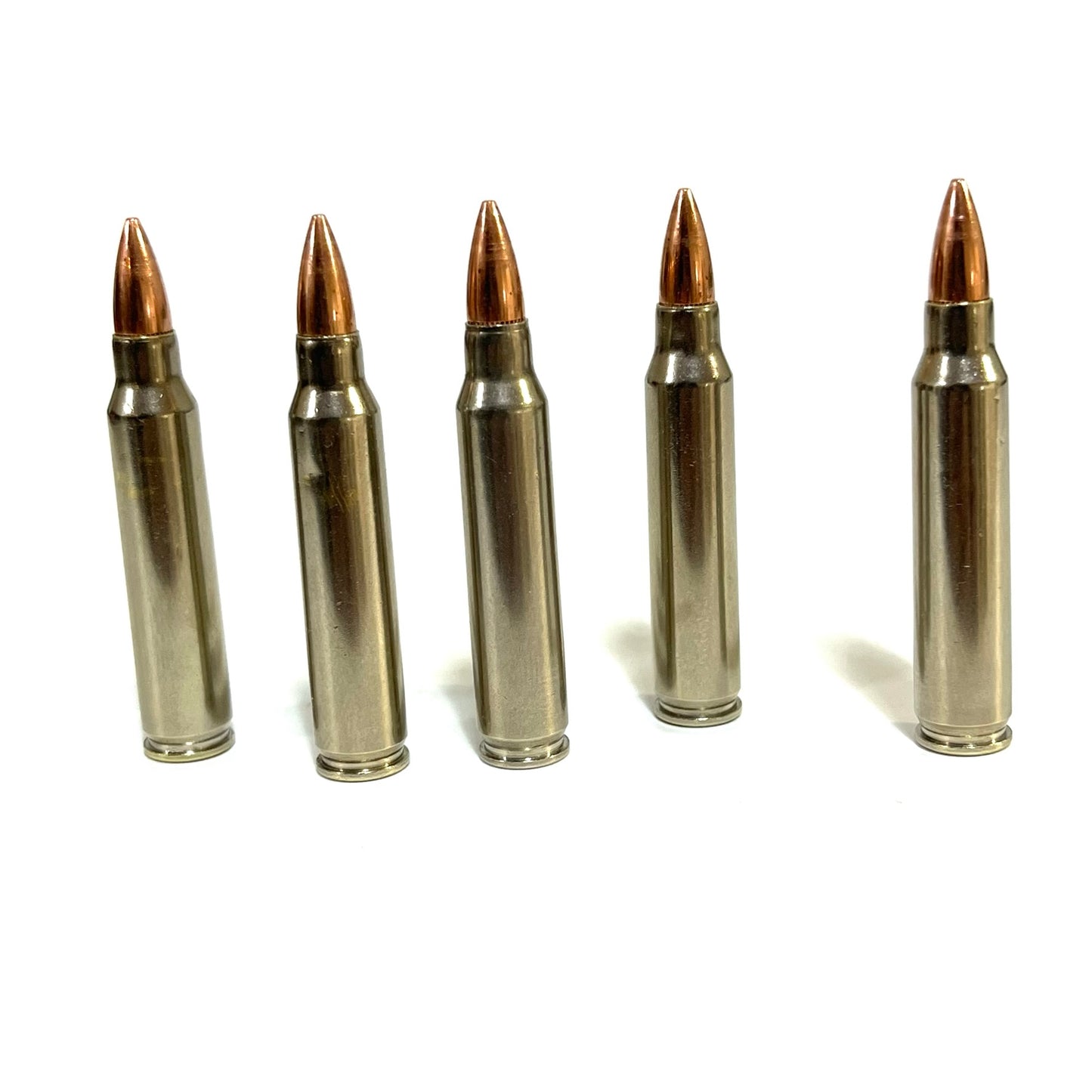 Five nickel-plated .223 dummy rifle cartridges standing vertically side-by-side in a row on a plain white background.