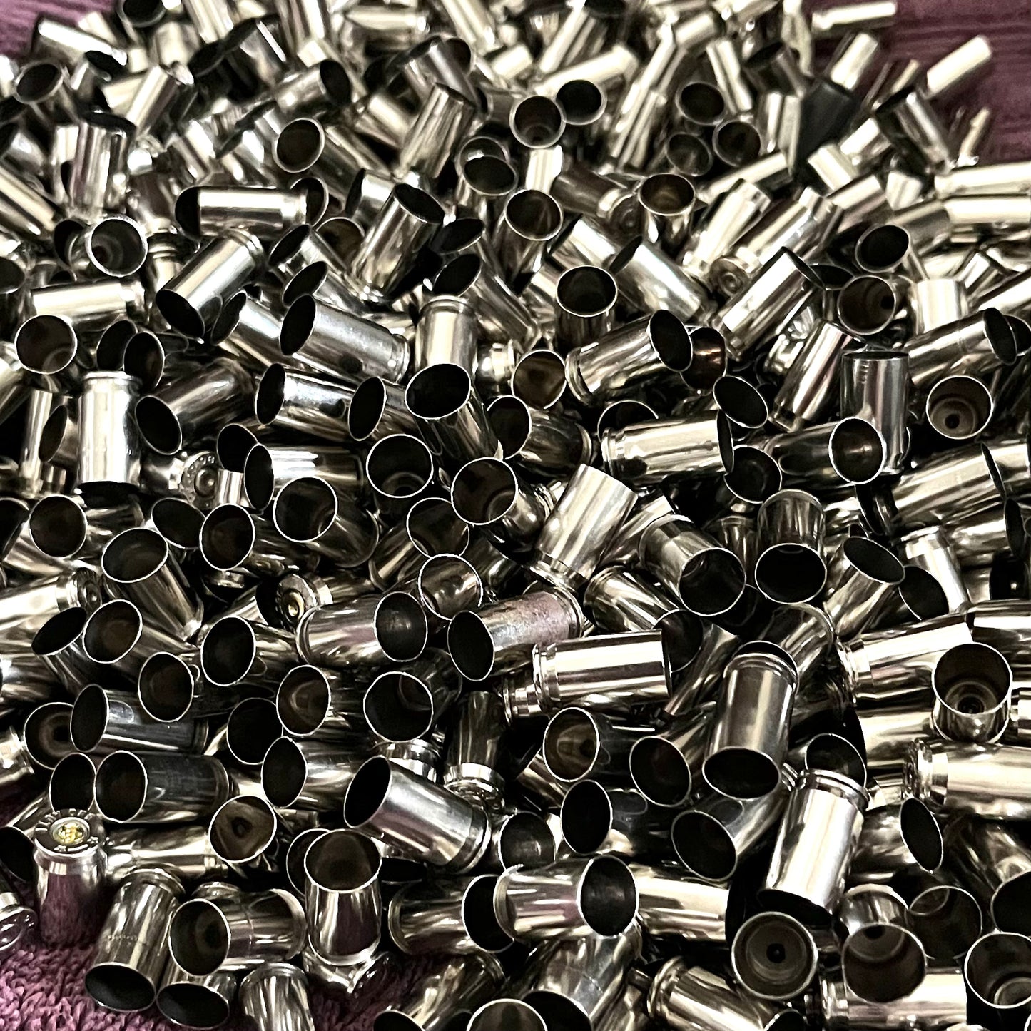 Nickel .380 Auto brass casings, once-fired empty shells. These are inert with no powder or live primers, ideal for rustic jewelry and crafting.
