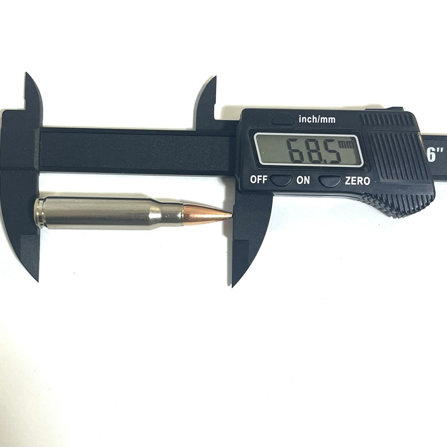 A single nickel-plated .308/7.62x51 dummy cartridge measured with digital calipers reading 68.5