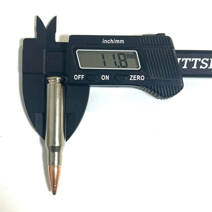 A single nickel-plated .308/7.62x51 dummy round measured vertically with calipers reading 11.8 mm