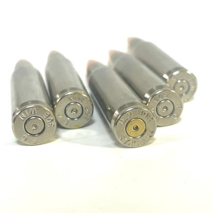 Five nickel .308 WIN dummy rounds shown base-first with visible headstamps and one brass-toned primer