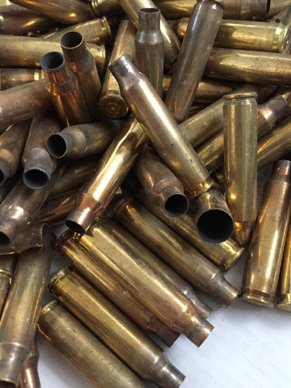 Large pile of once-fired 223 5.56 brass rifle casings from an AR-15