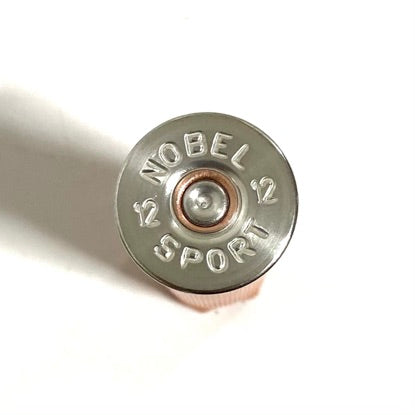 Close-up of an orange 12 gauge shotgun shell silver headstamp reading Nobel Sport 12