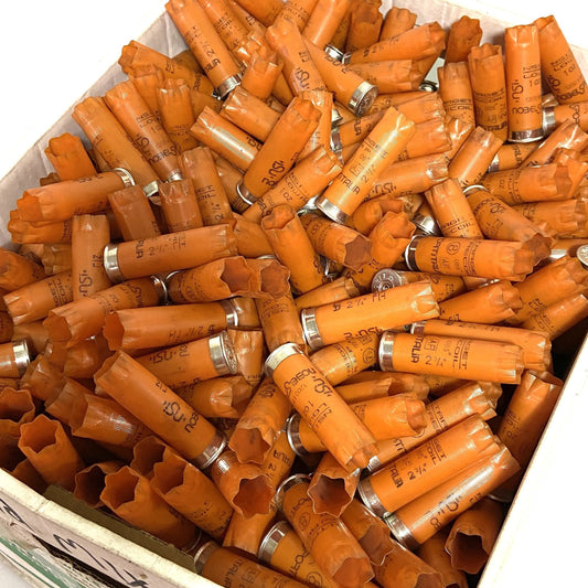 Hulls in orange color overflowing a white cardboard box in large quantities.