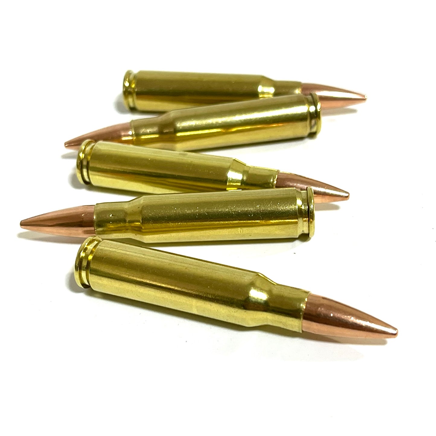 Five brass prop .308 dummy cartridges lying flat in a zigzag pattern on white background