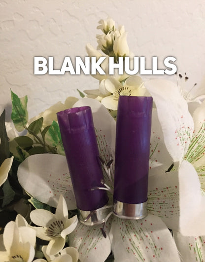 Two purple shotgun shell blank hulls with silver bases against white florals, Blank Hulls text overlay