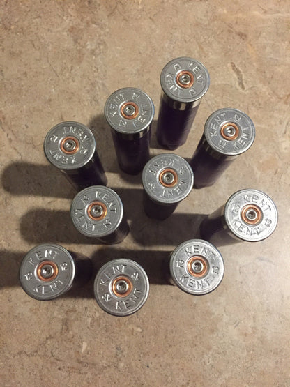 10 silver heads of purple Kent 12 gauge shotgun shells viewed from above showing KENT headstamp text