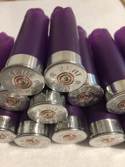 Cluster of purple shotgun shells viewed from silver base end, Kent 12 gauge headstamps with copper primers