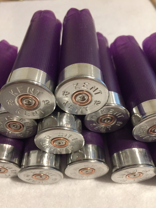 Cluster of purple shotgun shells viewed from silver base end, Kent 12 gauge headstamps with copper primers