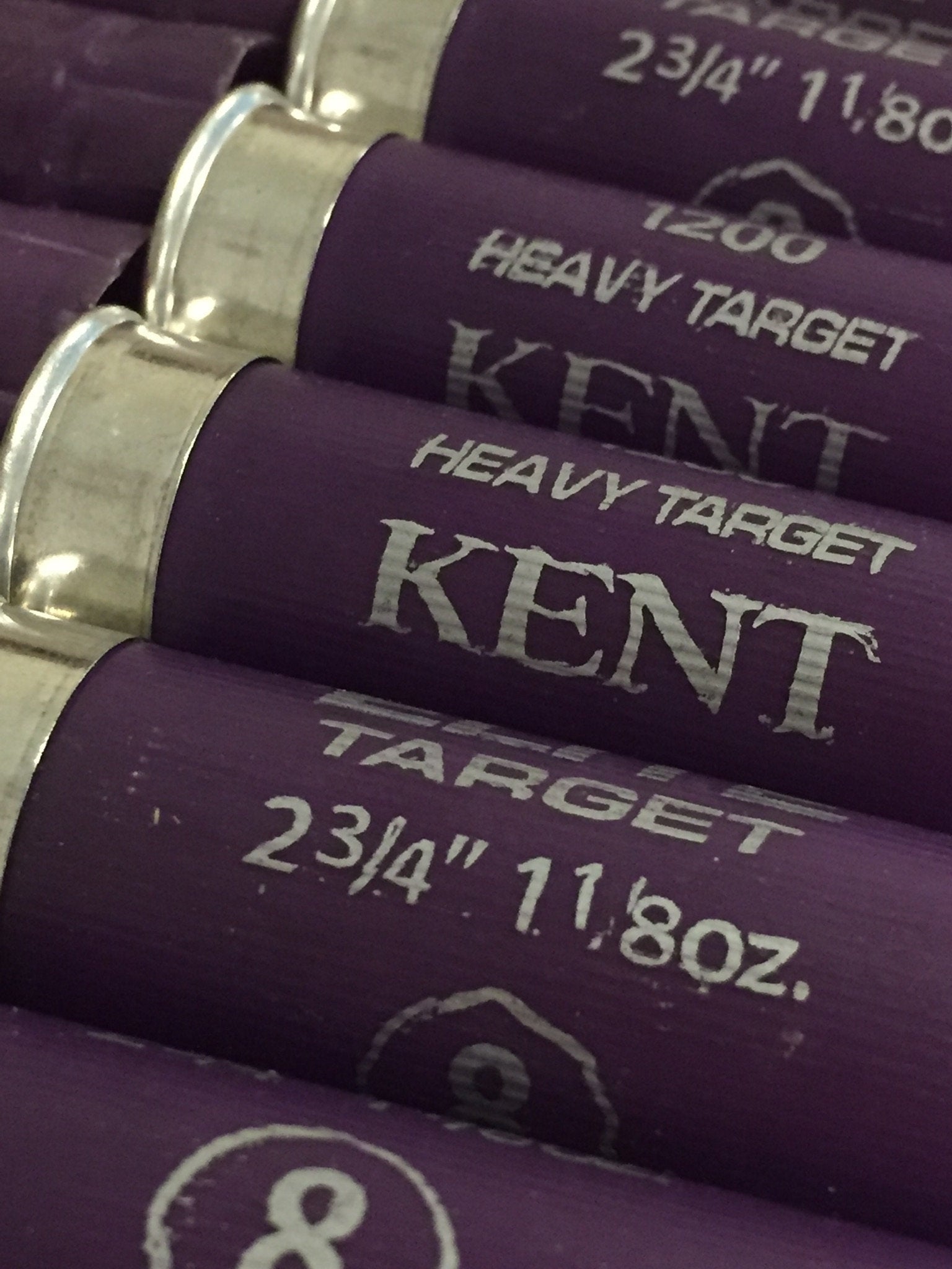 Close-up of silver heads on purple Kent shotgun shells showing metal band seams